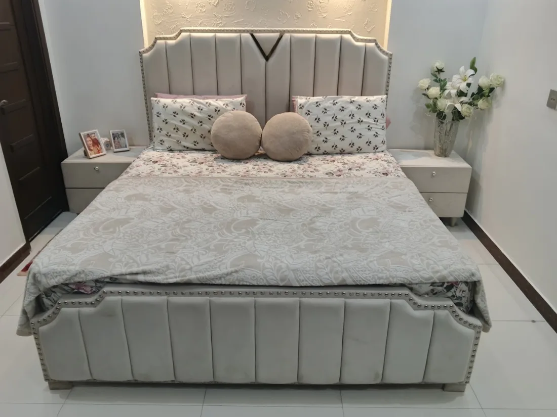 Upholstered bed with a tall channel-tufted grey headboard