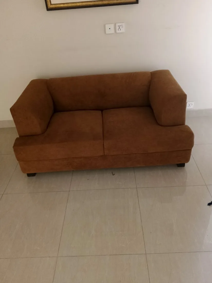Rust orange two-seater sofa