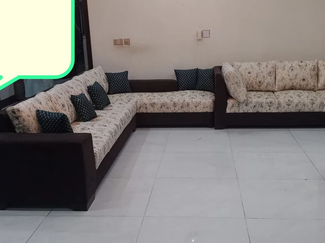 Floral L-shaped sofa with dark base